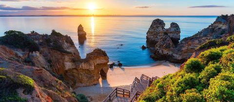 Cultural Treasures & Algarve Escape Portugal in 13 Days, 11 Nights in Destination Sunset over rock formations on Portugal's Algarve coast