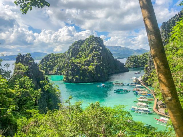 Turquoise lagoon between limestone cliffs in the Philippines
