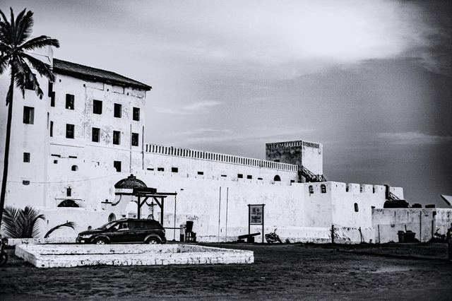 Cape Coast Castle's whitewashed walls on Ghana's coast, in black and white